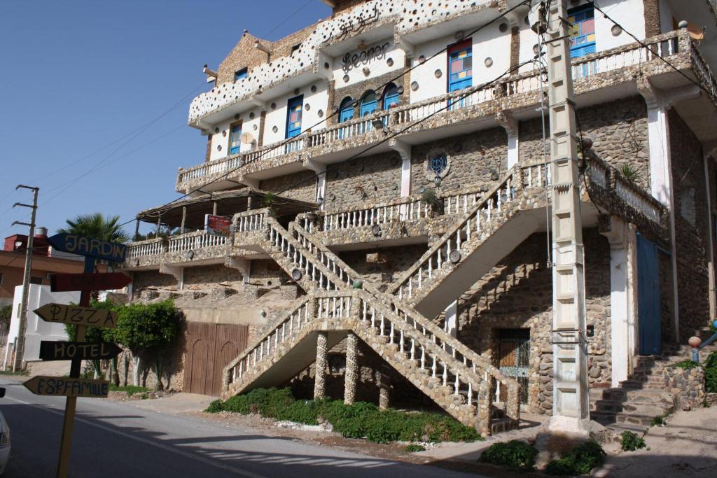 a building with stairs on the side of it at Hotel Leonor in Had Beni Chiker