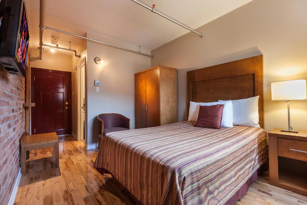 Postel nebo postele na pokoji v ubytování Hotel Abri du Voyageur