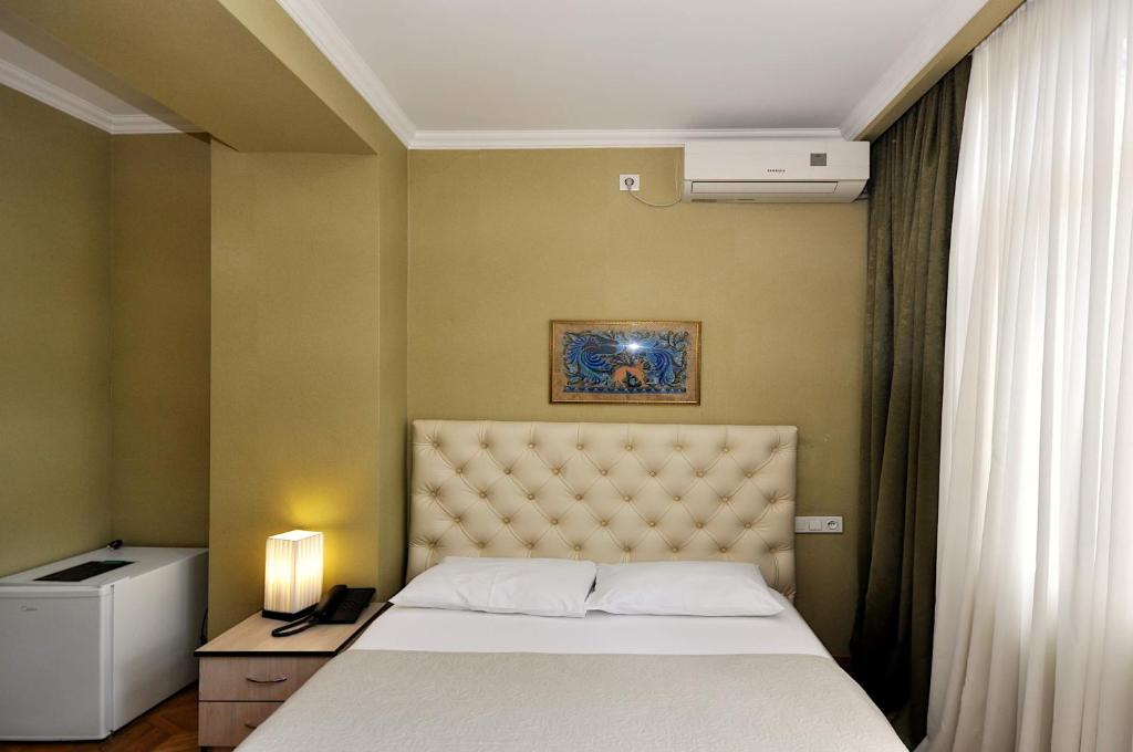 Postel nebo postele na pokoji v ubytování Hotel Frida