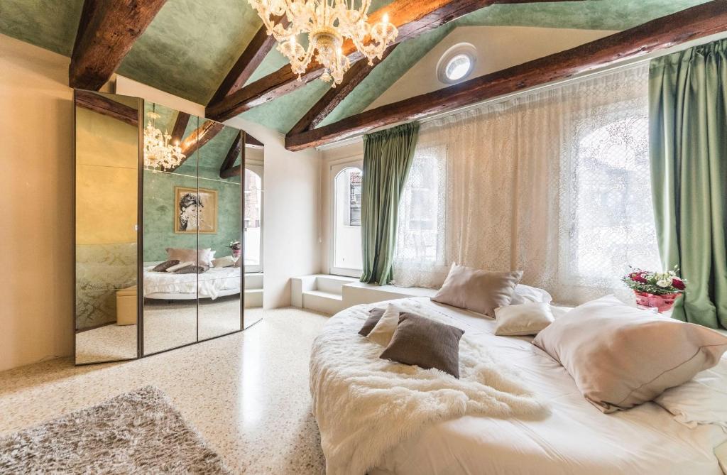 a bedroom with a large bed and a mirror at San Marco Terrace in Venice