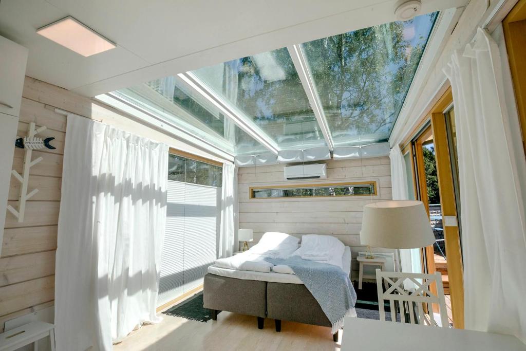 a small bedroom with a bed and a window at The Skylight Villa in Kemi