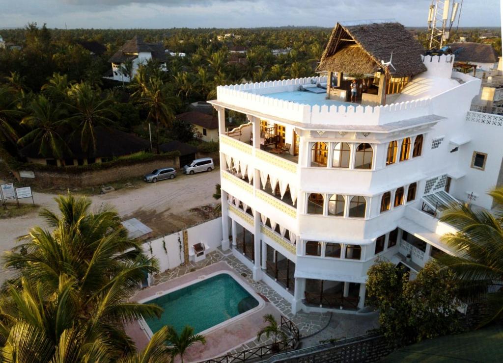 an aerial view of a white house with a swimming pool at Watamu Solana Apartments in Watamu