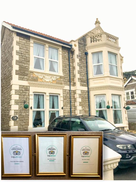 a building with a car parked in front of it at Milton Lodge in Weston-super-Mare
