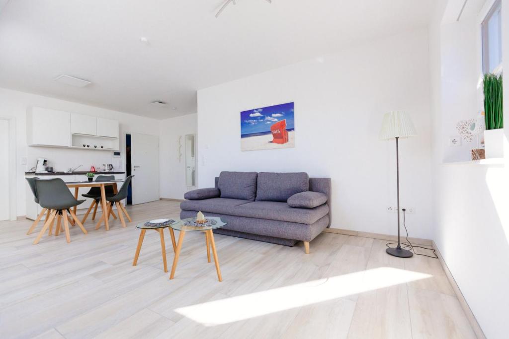 a living room with a couch and a table at Weserrobbe in Bremerhaven