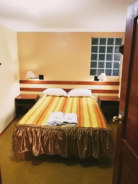 Postel nebo postele na pokoji v ubytování Conquista Cusco