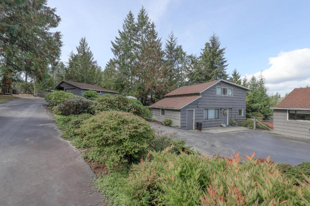 a house with a driveway next to a garage at The Tides Retreat in Gig Harbor