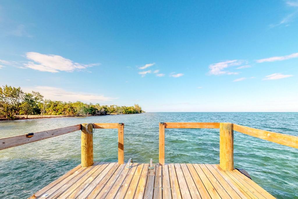 a wooden pier with a view of the water at Casa Corazón @ Eddie beach in Placencia