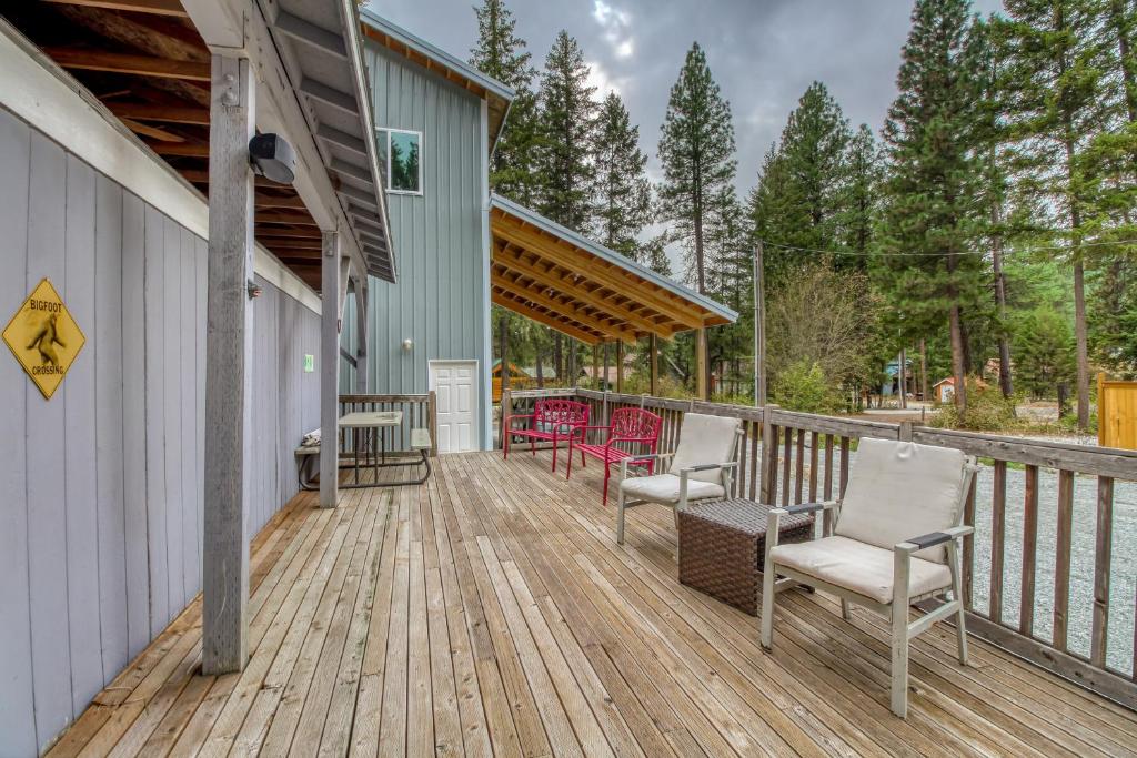 a wooden deck with chairs on a house at Pinecone Den in Leavenworth