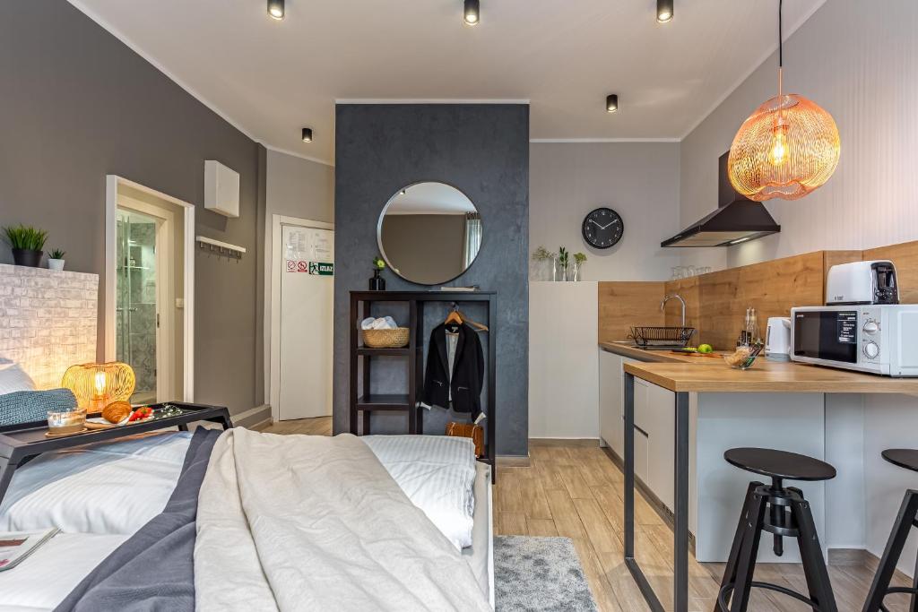 a kitchen and living room with a bed and a counter at Number 1 Apartments Rijeka in Rijeka