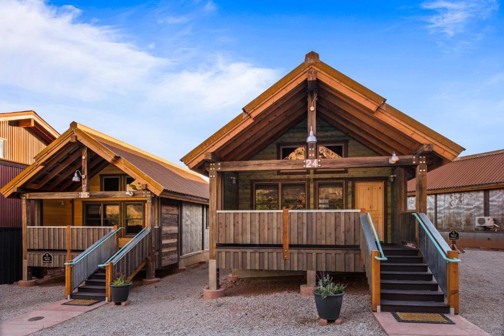 a large wooden house with a staircase in front of it at Moab Springs Ranch in Moab