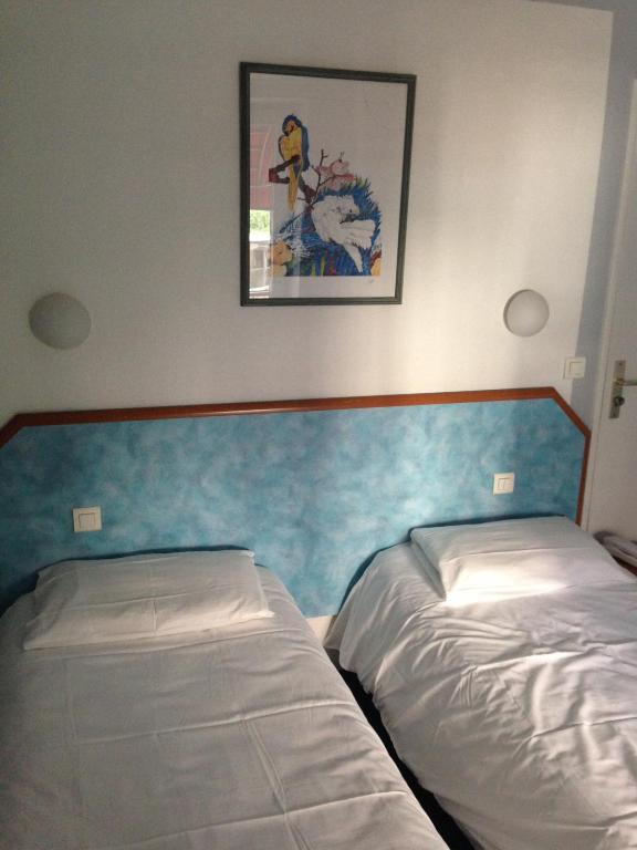 Ліжко або ліжка в номері Hotel Royal Mansart