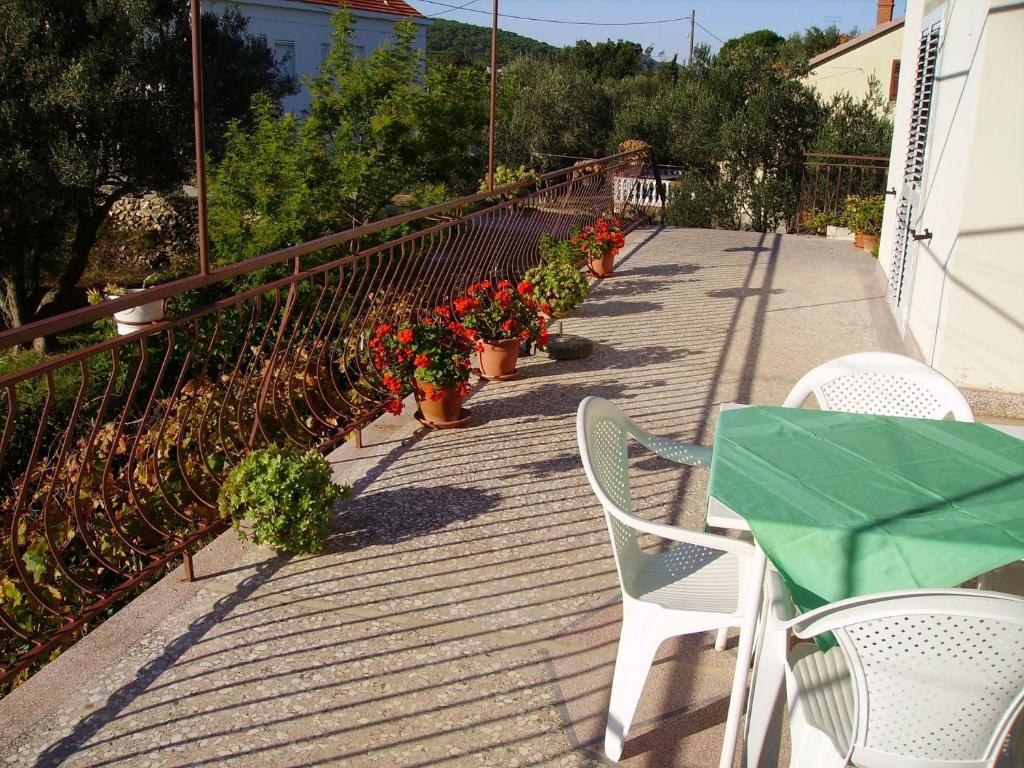 a patio with a table and chairs and potted plants at Apartment Mili - 50m from beach in Sutomišćica