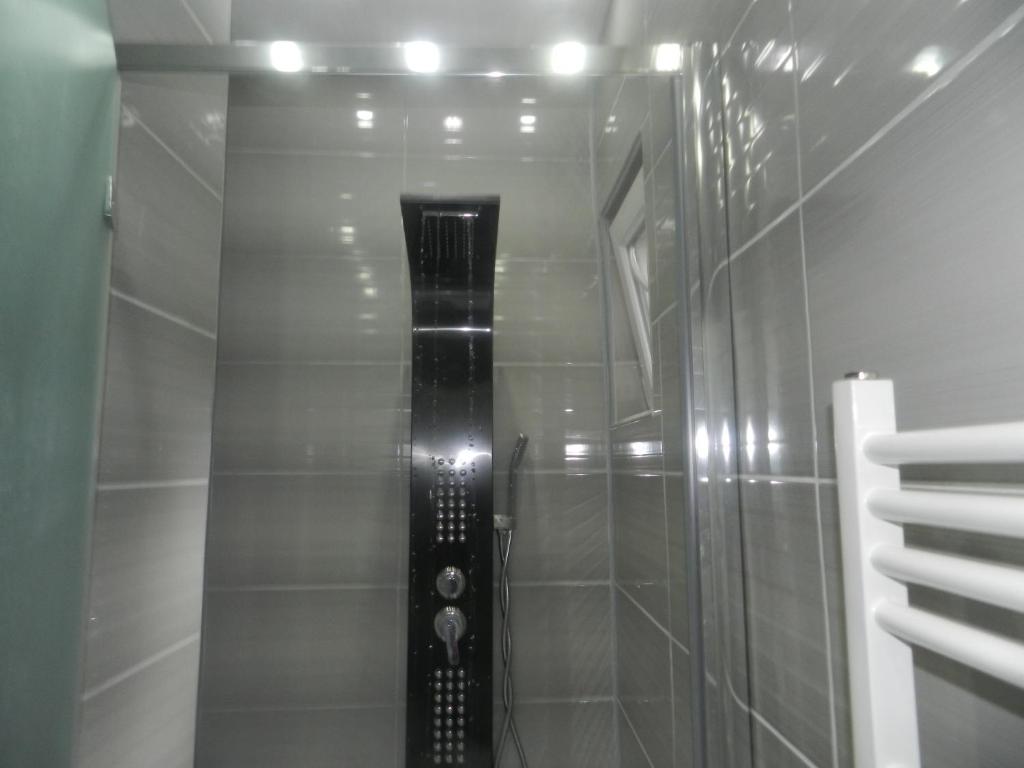 a shower with a glass door in a bathroom at apartmani mejdan in Tuzla