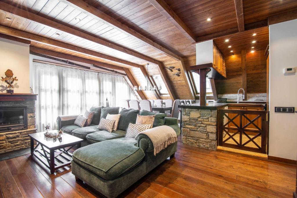 a living room with a couch and a fireplace at ADELAIDA de Alma de Nieve in Baqueira-Beret