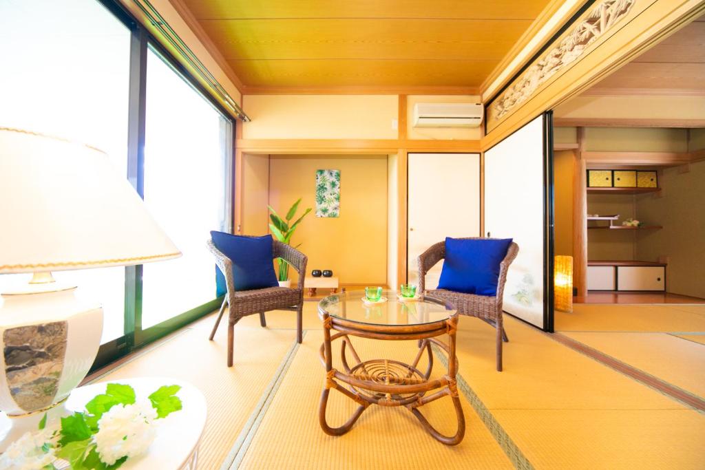 a living room with a glass table and chairs at Awaji Seaside Resort in Shiduki in Awaji