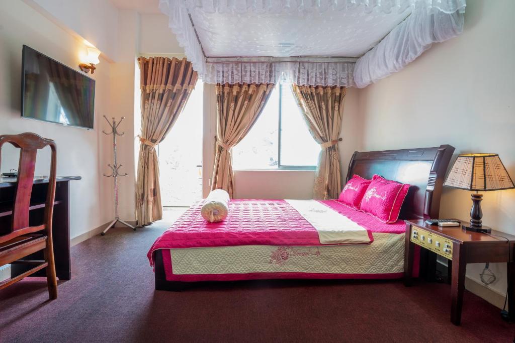 a bedroom with a pink bed with a teddy bear on it at AD 41 Hotel Huế CS2 in Hue