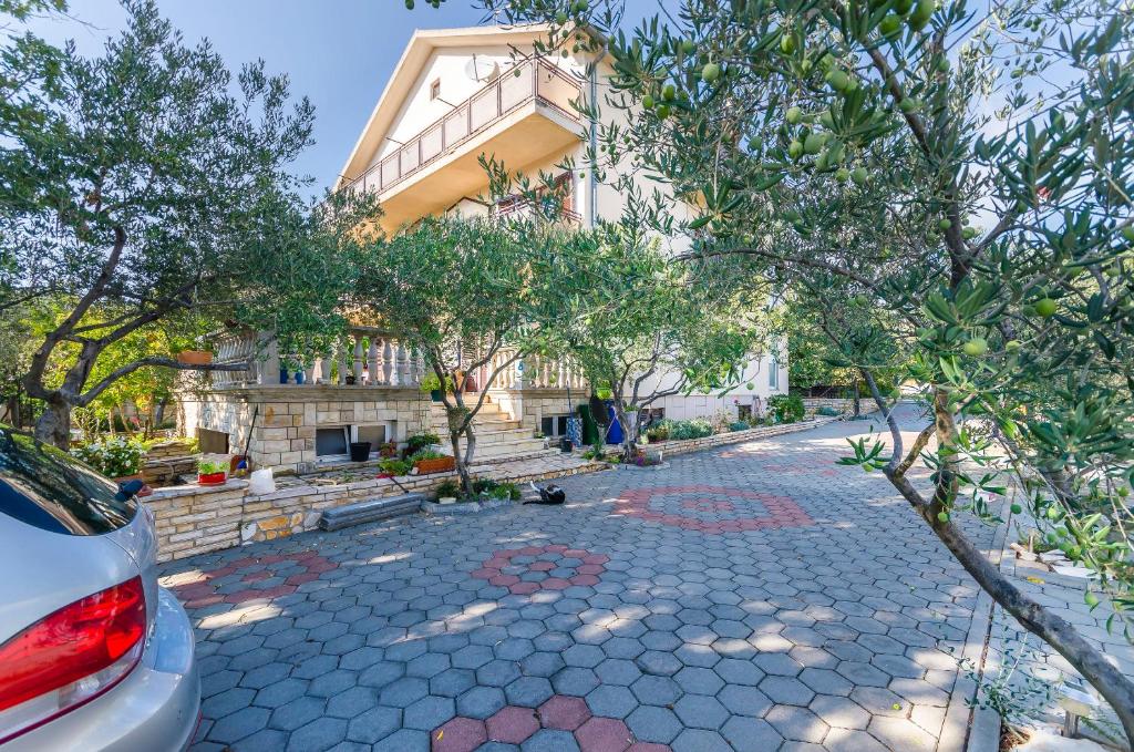 a house on a street with trees in front of it at Apartment Jasna summer barbeque in Srima