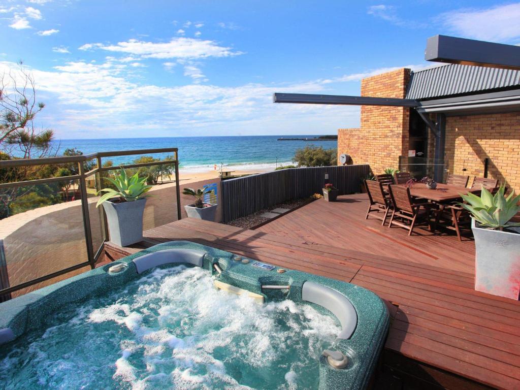 uma banheira de hidromassagem num deque com vista para a praia em Spectacular Location and Views, 3 Bedrooms , Private Rooftop Spa em Mooloolaba