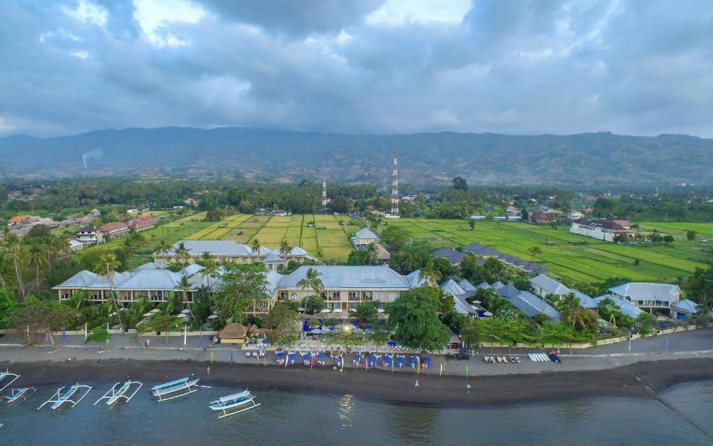 an aerial view of a resort with boats in the water at The Lovina in Lovina