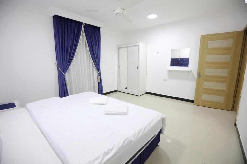 Postel nebo postele na pokoji v ubytování Al Rayyan Hotel Apartments Muscat