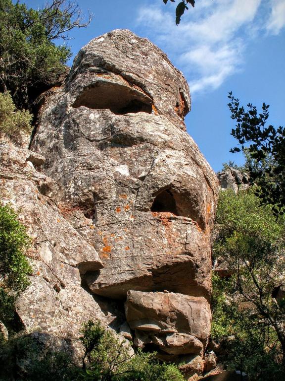 a large rock with a face on it at Hotel Bia Maore in Baunei