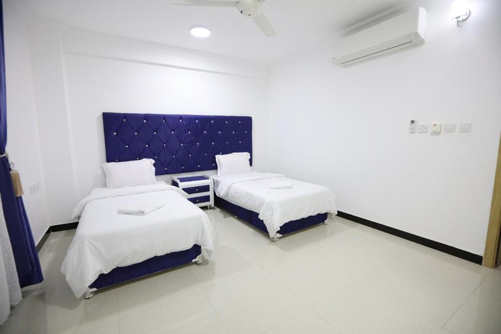 Postel nebo postele na pokoji v ubytování Al Rayyan Hotel Apartments Muscat