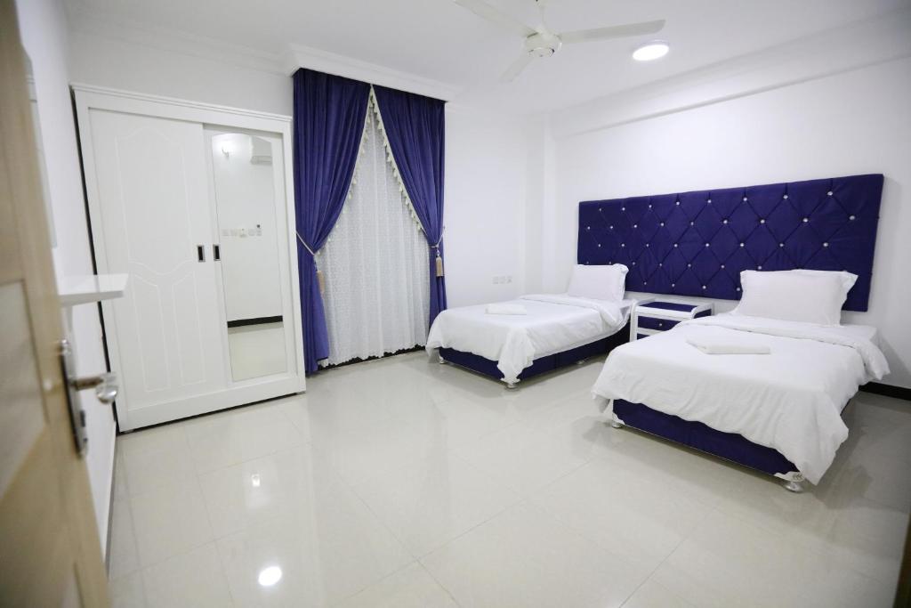 Postel nebo postele na pokoji v ubytování Al Rayyan Hotel Apartments Muscat