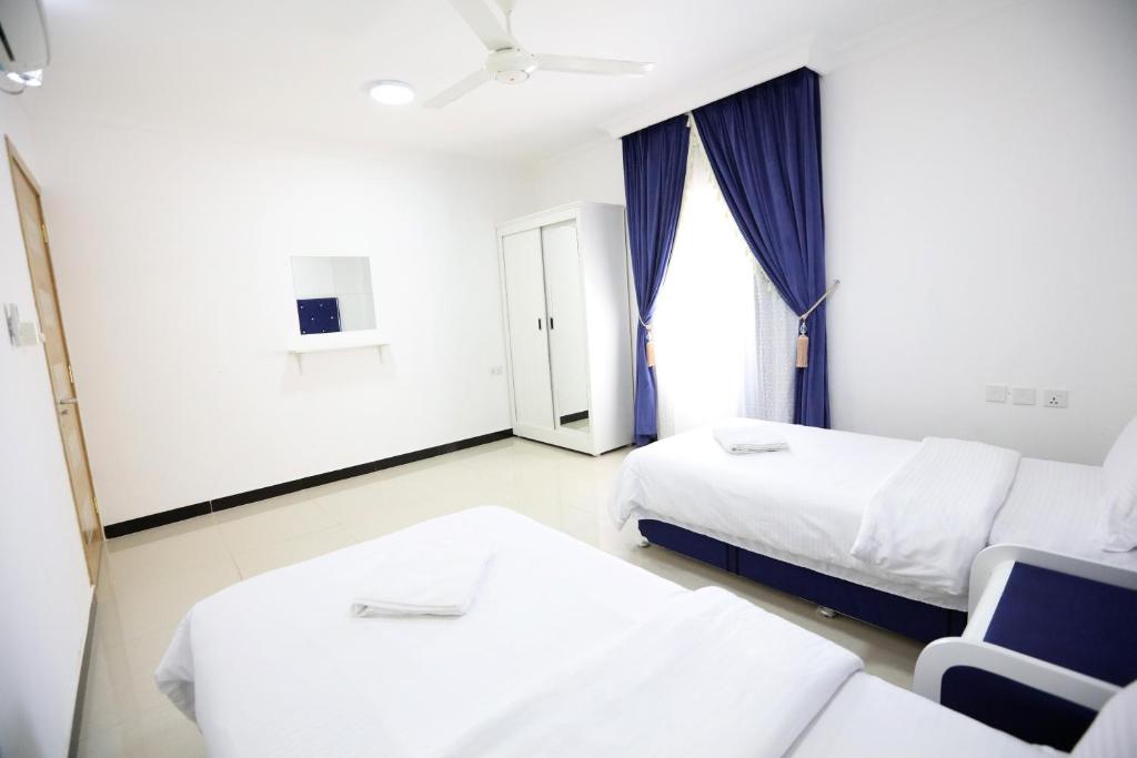 Postel nebo postele na pokoji v ubytování Al Rayyan Hotel Apartments Muscat