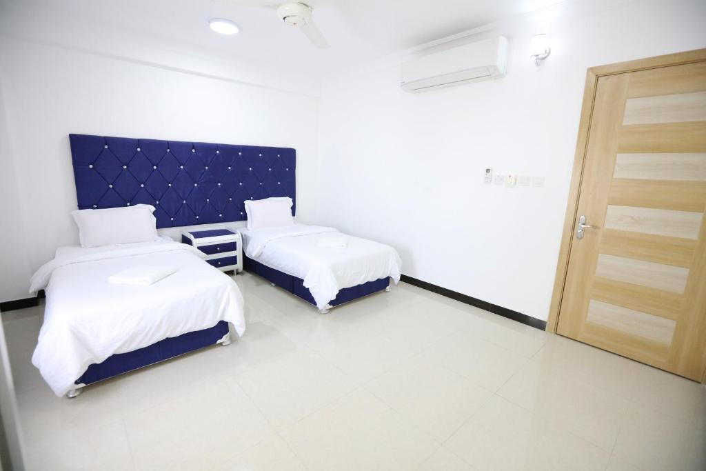 Postel nebo postele na pokoji v ubytování Al Rayyan Hotel Apartments Muscat