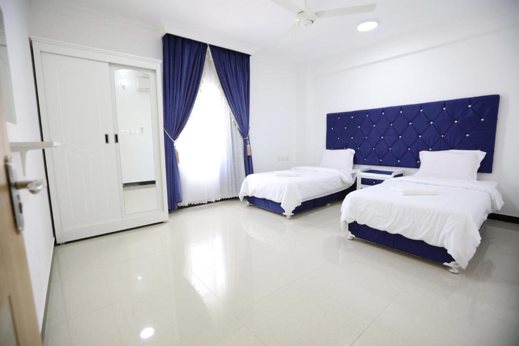Postel nebo postele na pokoji v ubytování Al Rayyan Hotel Apartments Muscat