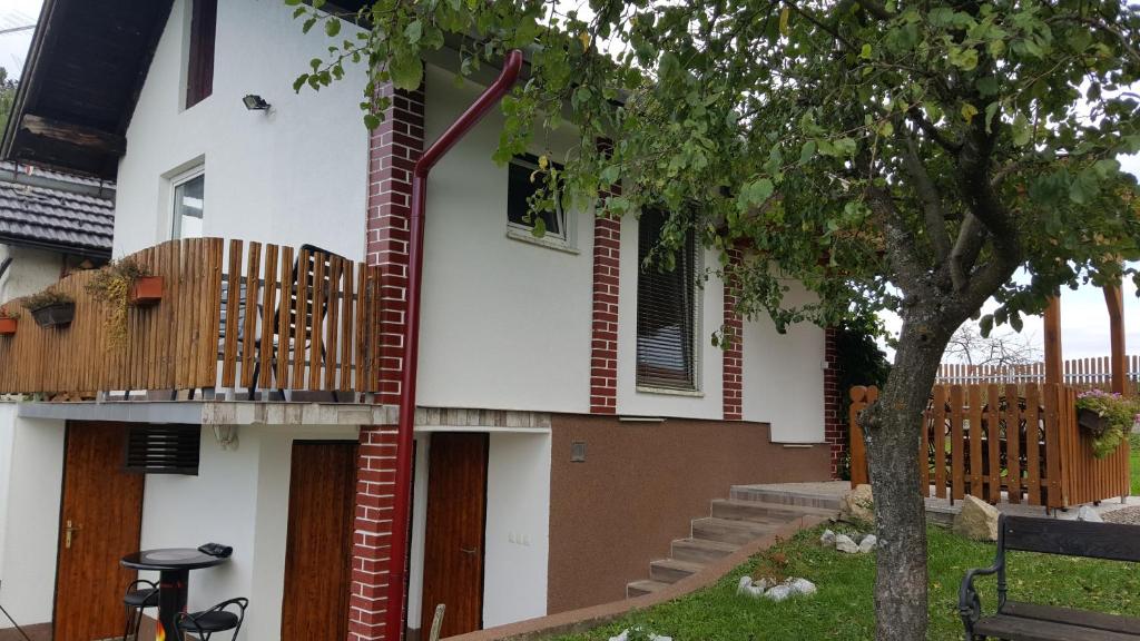 a house with a deck on the side of it at Kuca za odmor Vinica breg in Varaždin