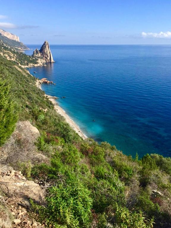 a view of the ocean from a hill at Hotel Bia Maore in Baunei