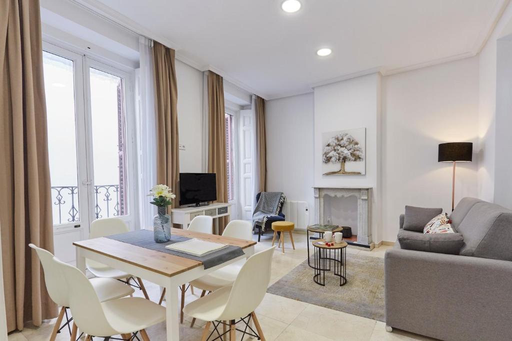 a living room with a table and a couch at LEEWAYS APARTMENT XVIII in GRAN VÍA in Madrid