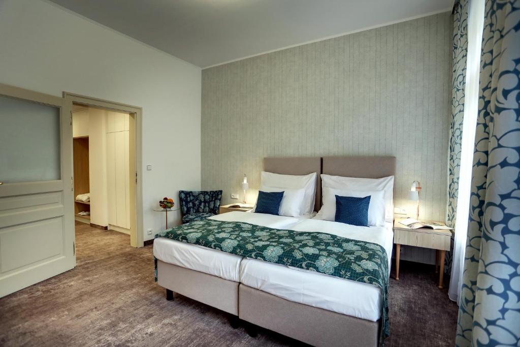 Postel nebo postele na pokoji v ubytování ASTORIA Hotel & Medical Spa