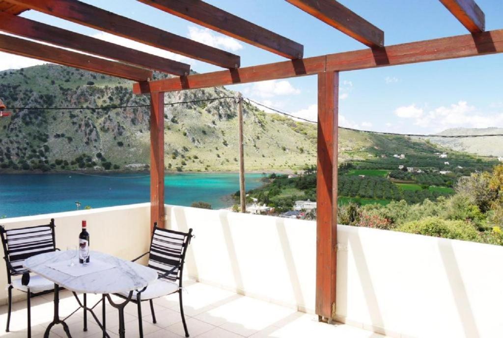 a patio with a table and chairs and a view of the ocean at Villa Elan in Mouríon