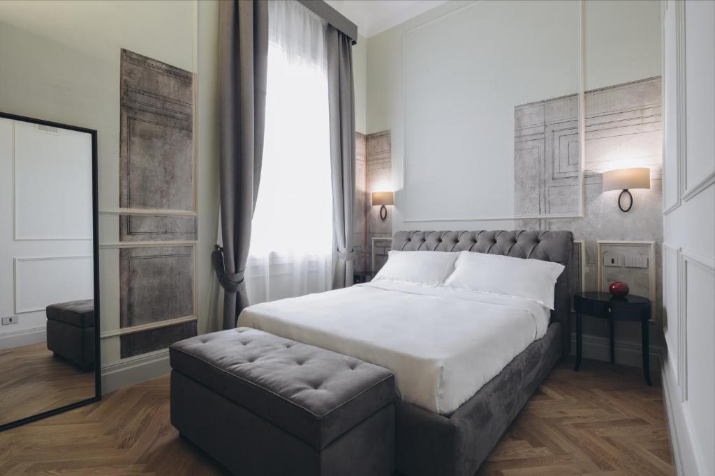 Posteľ alebo postele v izbe v ubytovaní Gregorini Bingham Art Luxury Suites