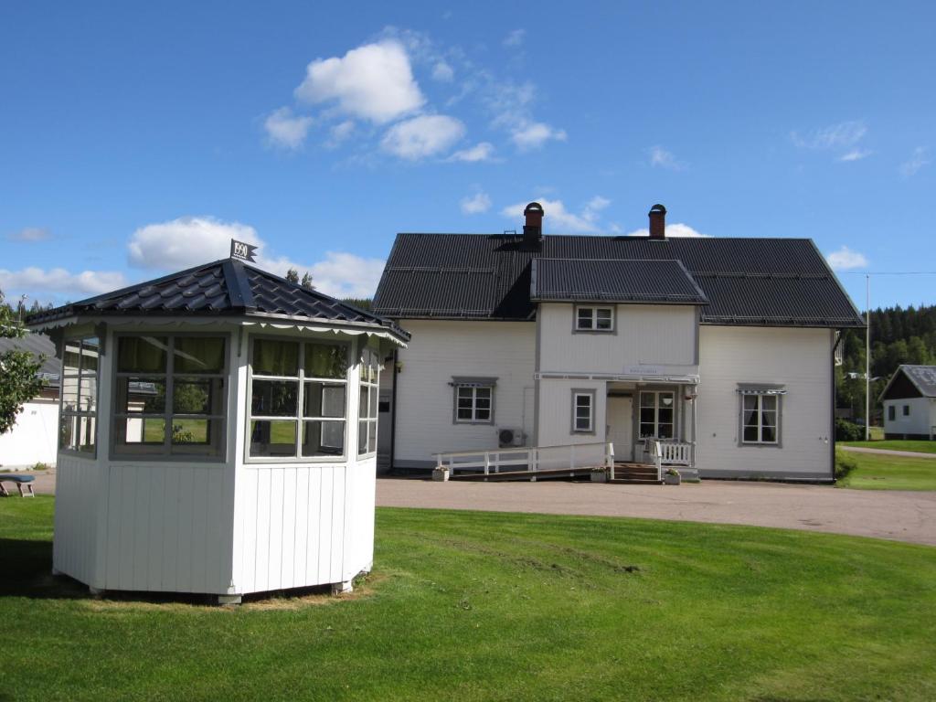 a large white house with a white building at Sörnäsgården Bed & Breakfast in Lima