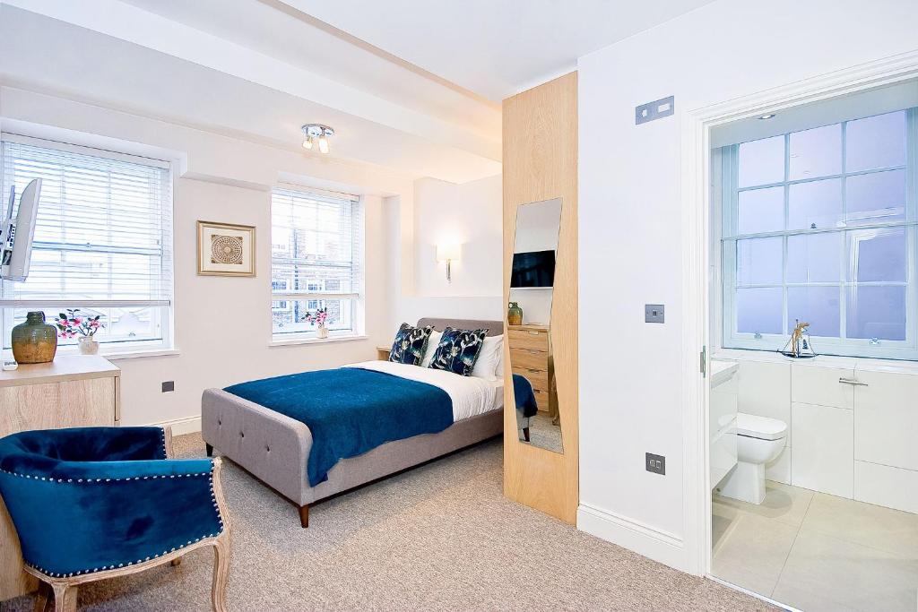 a bedroom with a bed and a bathroom at Eldon Chambers Pod 5 by City Living London in London