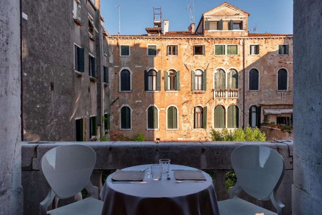 a table and chairs on a balcony with a building at Sogno di Giulietta e Romeo in Venice