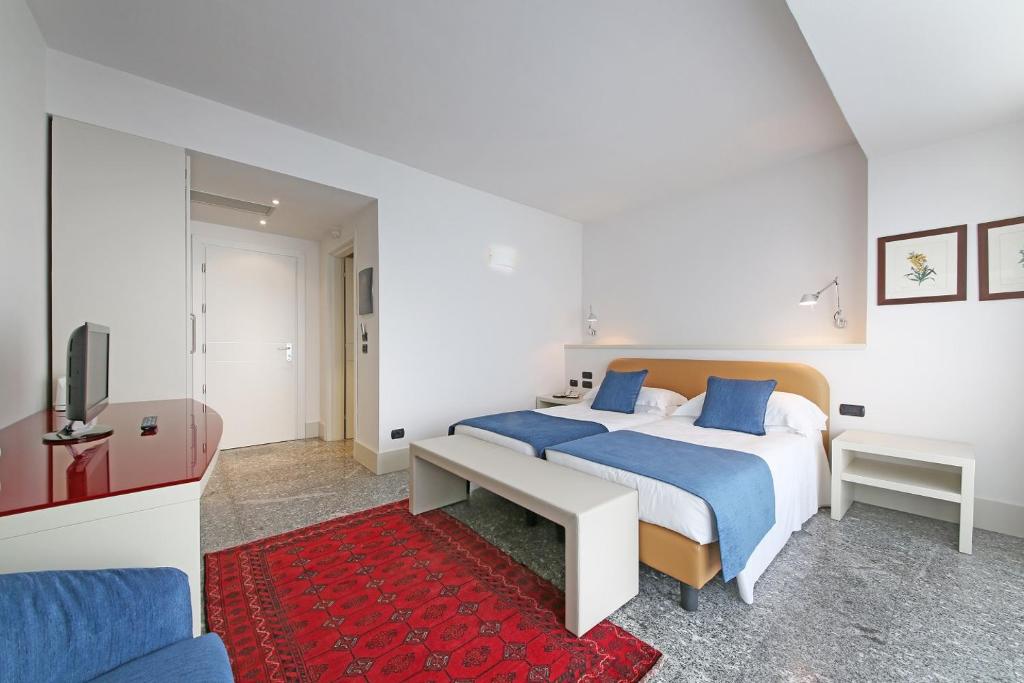 Postel nebo postele na pokoji v ubytování Hotel Salò du Parc