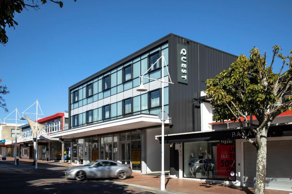 a car parked in front of a building on a street at Quest Tauranga Central in Tauranga