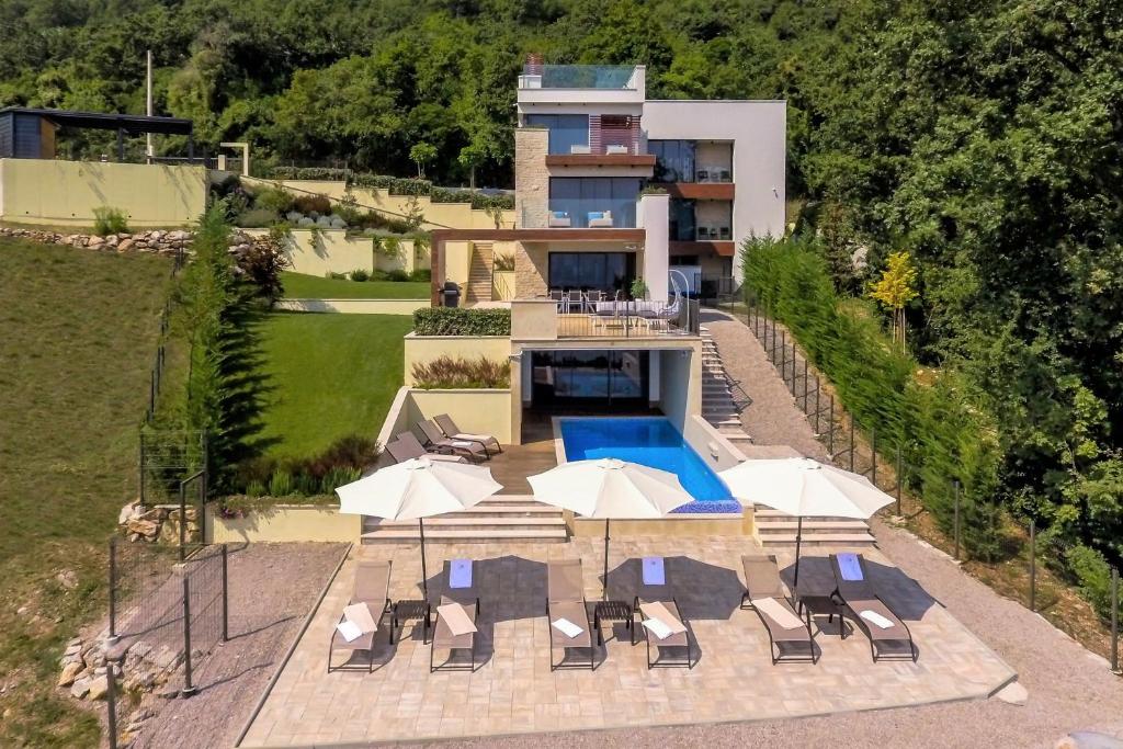 an aerial view of a house with a swimming pool at Villa AltaVista - Seaview & Relax with Heated Pool & MiniGolf in Opatija