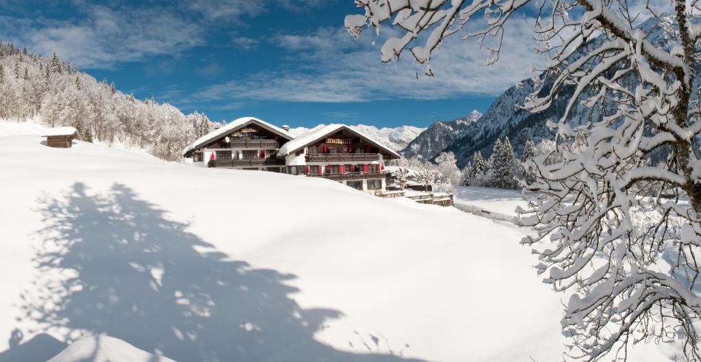 a ski lodge in the snow on a mountain at Alpengasthof Hotel Schwand in Oberstdorf