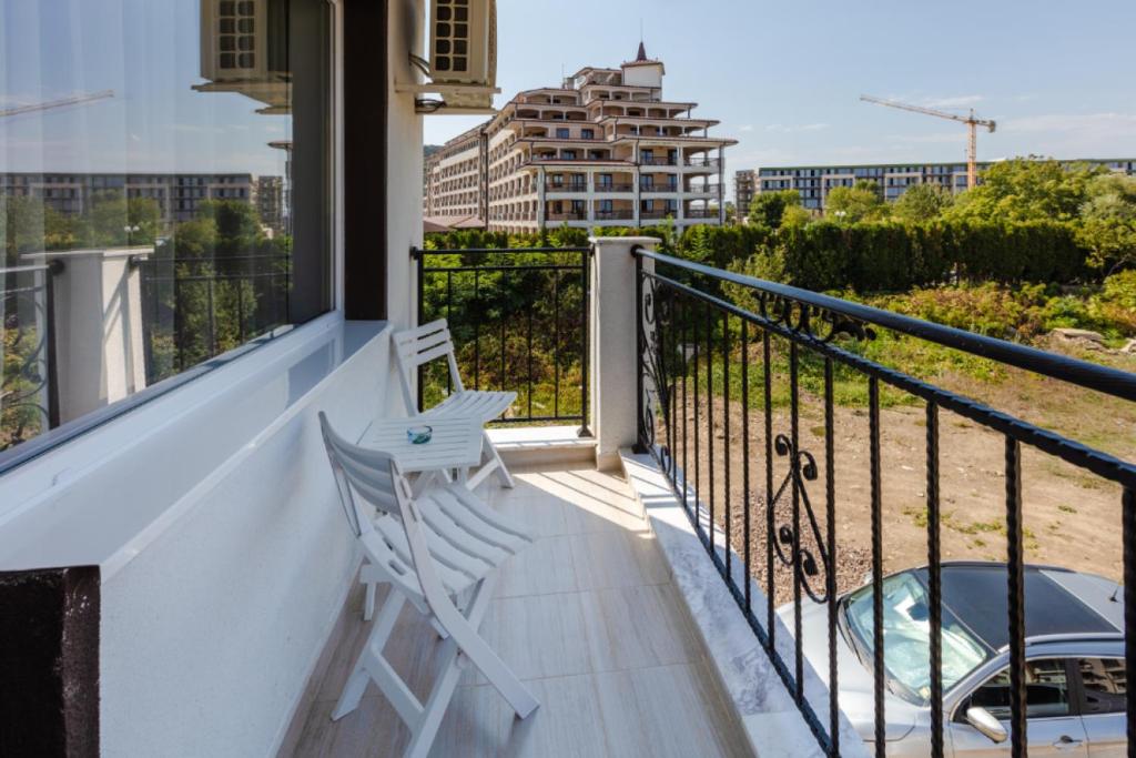 a white chair sitting on the balcony of a building at Guest House Theona in Obzor