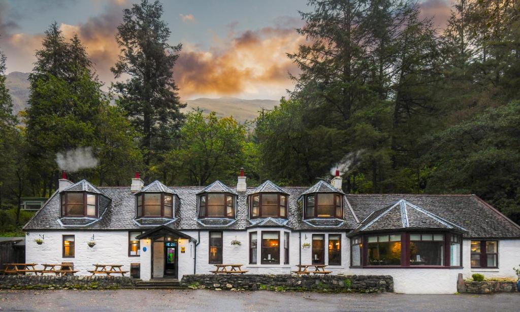 a large white house with a lot of windows at The Coylet Inn by Loch Eck in Dunoon