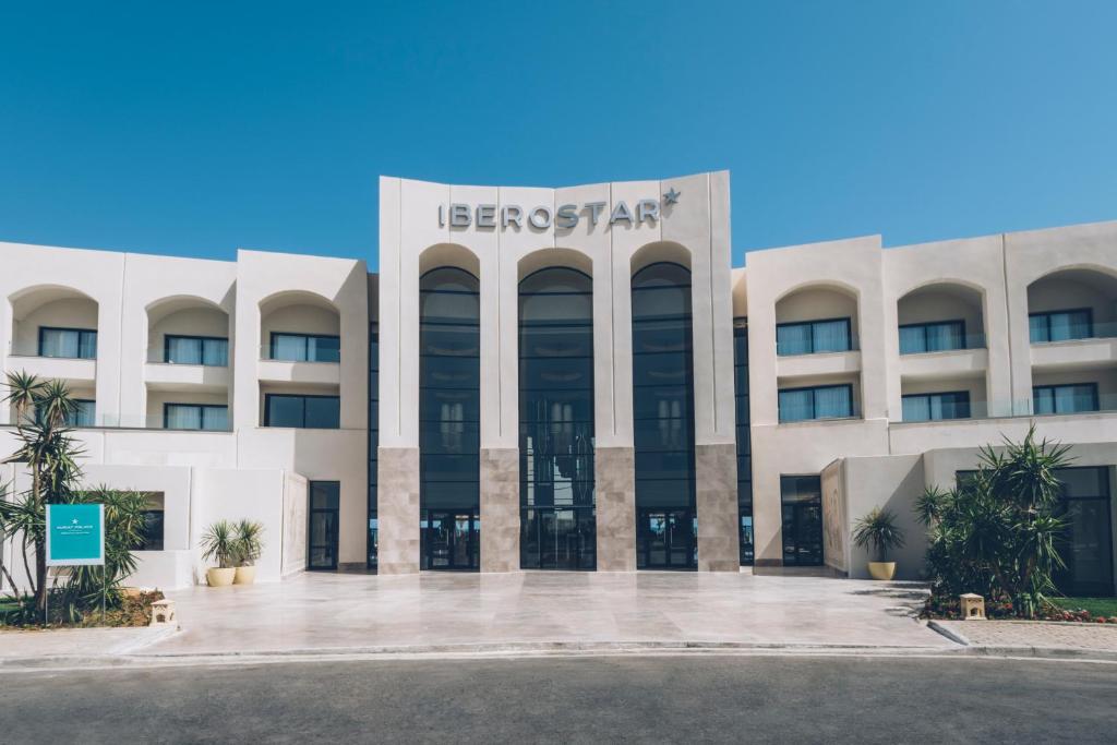a large white building with a sign on it at Iberostar Selection Kuriat Palace in Monastir