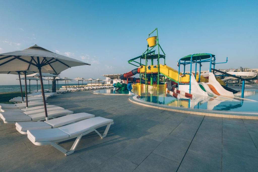 a pool with a water park with a roller coaster at Iberostar Selection Kuriat Palace in Monastir