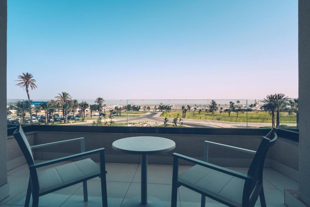 a table and chairs on a balcony with a view of the beach at Iberostar Selection Kuriat Palace in Monastir