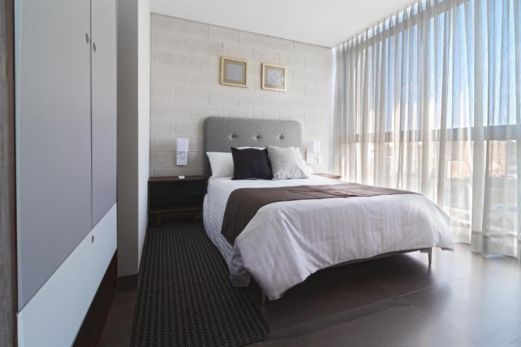 Postel nebo postele na pokoji v ubytování Arboleda 5 Luxury Lofts