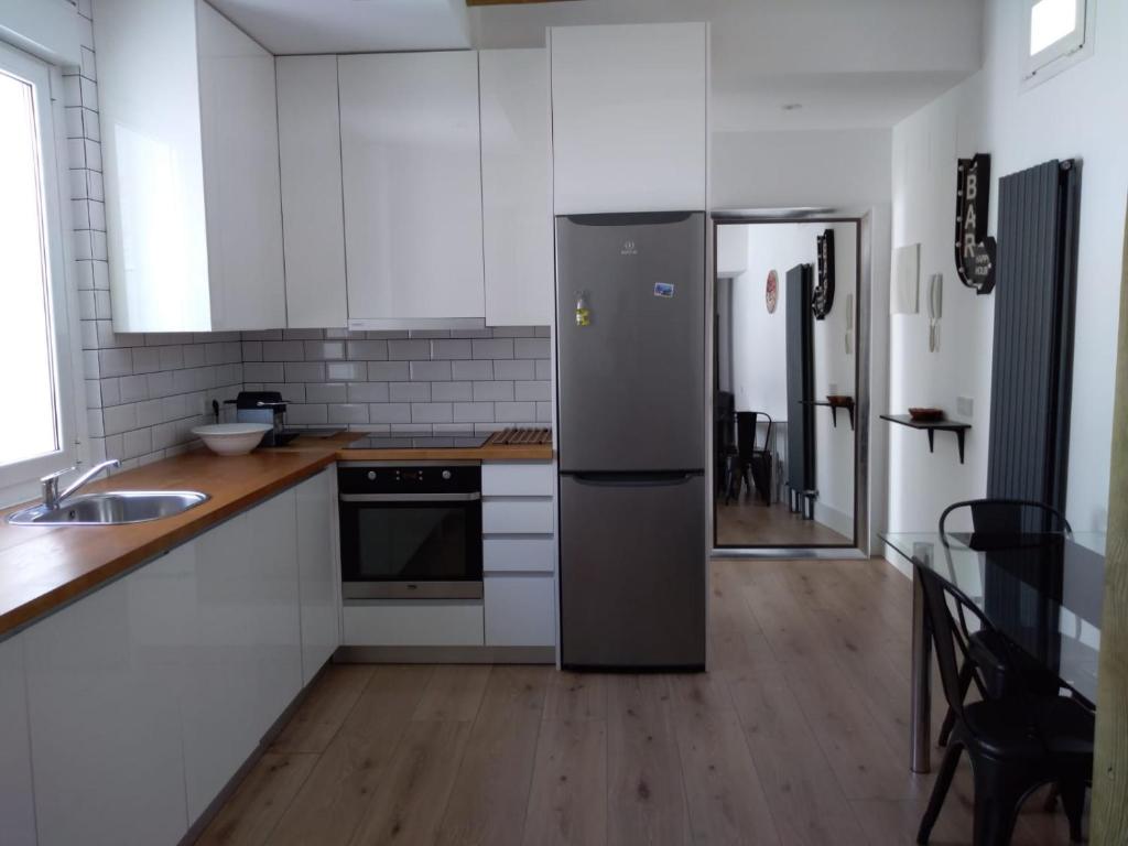 a kitchen with a stainless steel refrigerator and a sink at Great apartment with excellent location (Calle Fuencarral/Gran Via/Chueca) in Madrid